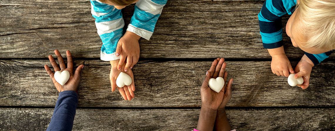 Childrens hand with hearts in them.