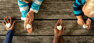 Childrens hand with hearts in them.