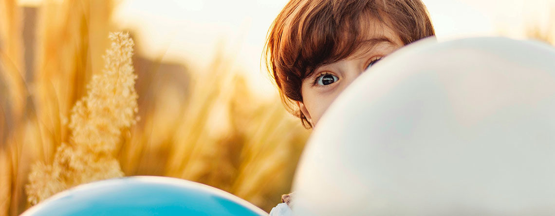 Child Peeps over Balloon, Surprised