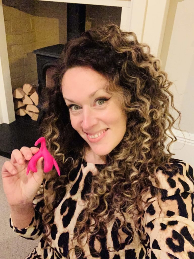 Dr. Naomi Sutton holds a life size model of a clitoris